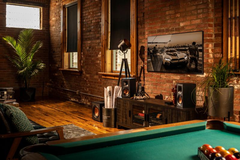 Klipsch Reference Powered Speakers by a pool table